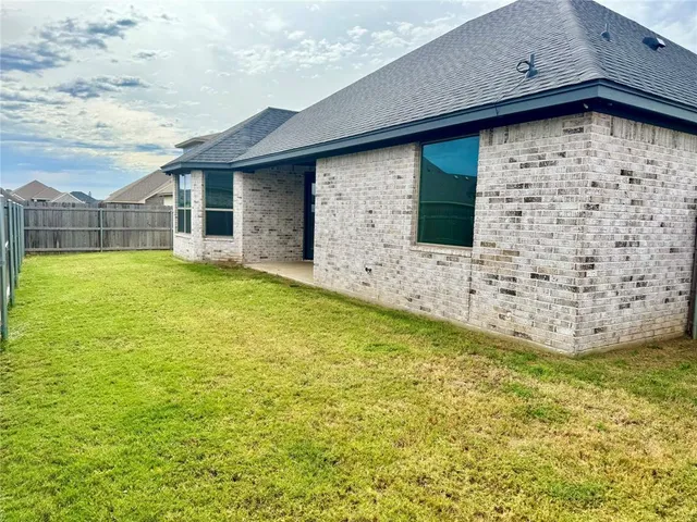 a view of house with yard