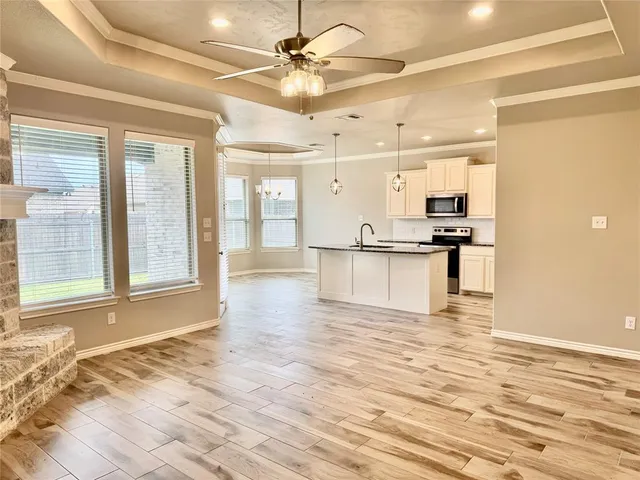 a view of a kitchen with a sink and a refrigerator