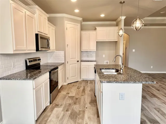 a kitchen with a sink stove and refrigerator