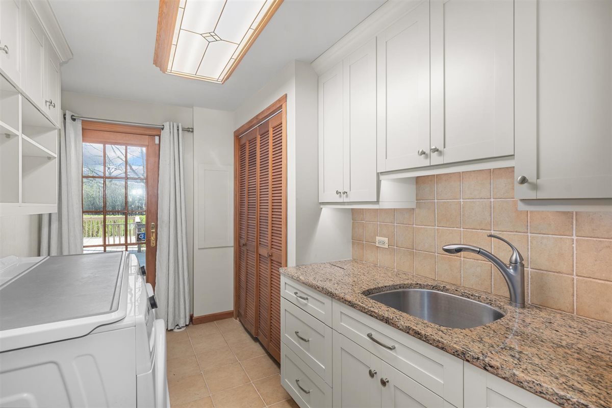 1760 Telegraph Road Lake Forest, IL 60045 - Photo 20 of 50 a kitchen with granite countertop a sink stainless steel appliances white cabinets and a window