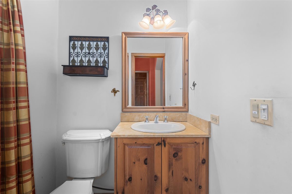 1760 Telegraph Road Lake Forest, IL 60045 - Photo 22 of 50 a bathroom with a sink a toilet a mirror and shower curtain