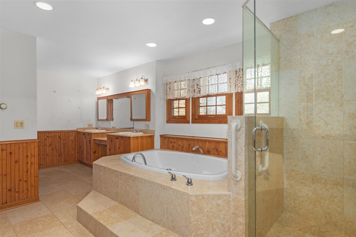 1760 Telegraph Road Lake Forest, IL 60045 - Photo 26 of 50 a bathroom with a tub a sink and a window