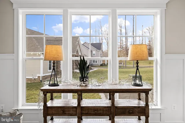 a living room with furniture a dining table and a chandelier