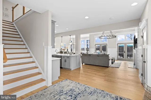 a living room with furniture a chandelier and a flat screen tv