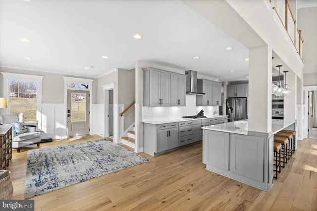 a dining room with furniture a chandelier and wooden floor