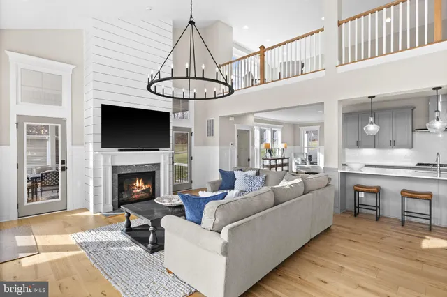 a view of living room kitchen with furniture and wooden floor