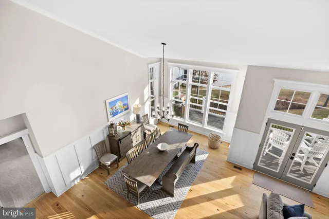 a dining room with furniture a chandelier and wooden floor