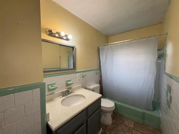 a bathroom with a sink mirror toilet and bathtub