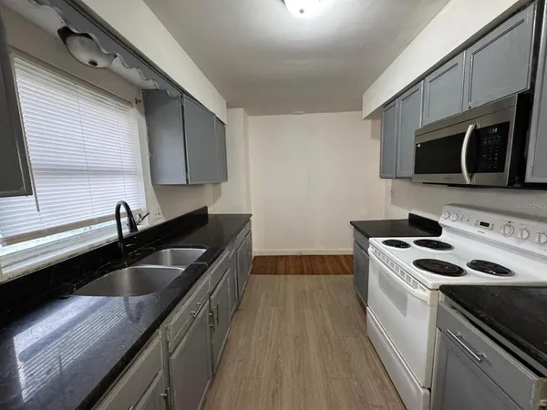 a kitchen with stainless steel appliances a sink stove and refrigerator