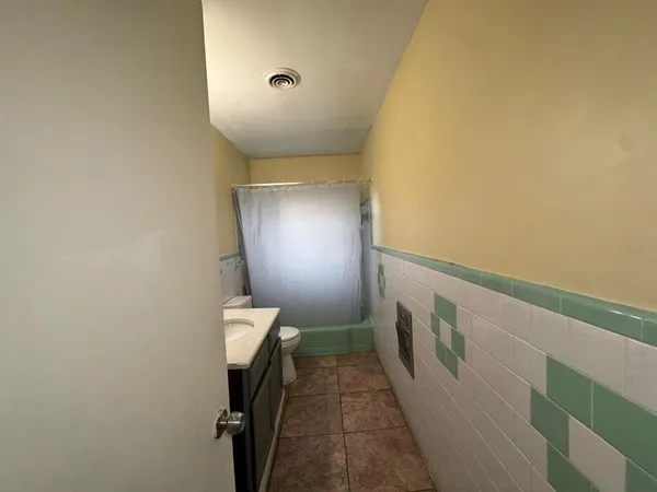 a bathroom with a sink toilet and mirror
