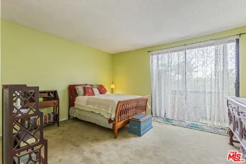 a bed sitting in a room next to a window