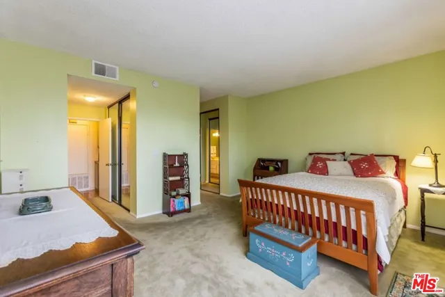 a bedroom with a bed and a dresser