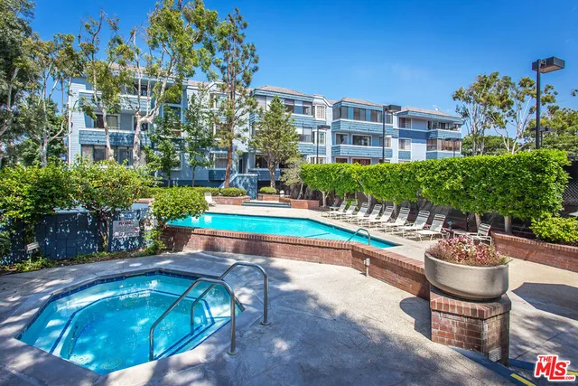 a swimming pool with outdoor seating and yard