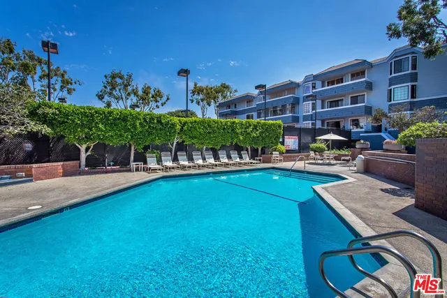 a view of a swimming pool with a patio