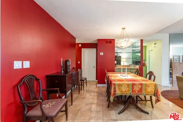 a view of a dining room with furniture and chandelier