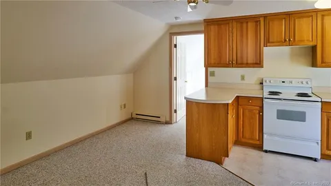 a kitchen with a stove top oven cabinets and a refrigerator