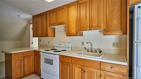 a kitchen with stainless steel appliances a stove a sink and cabinets