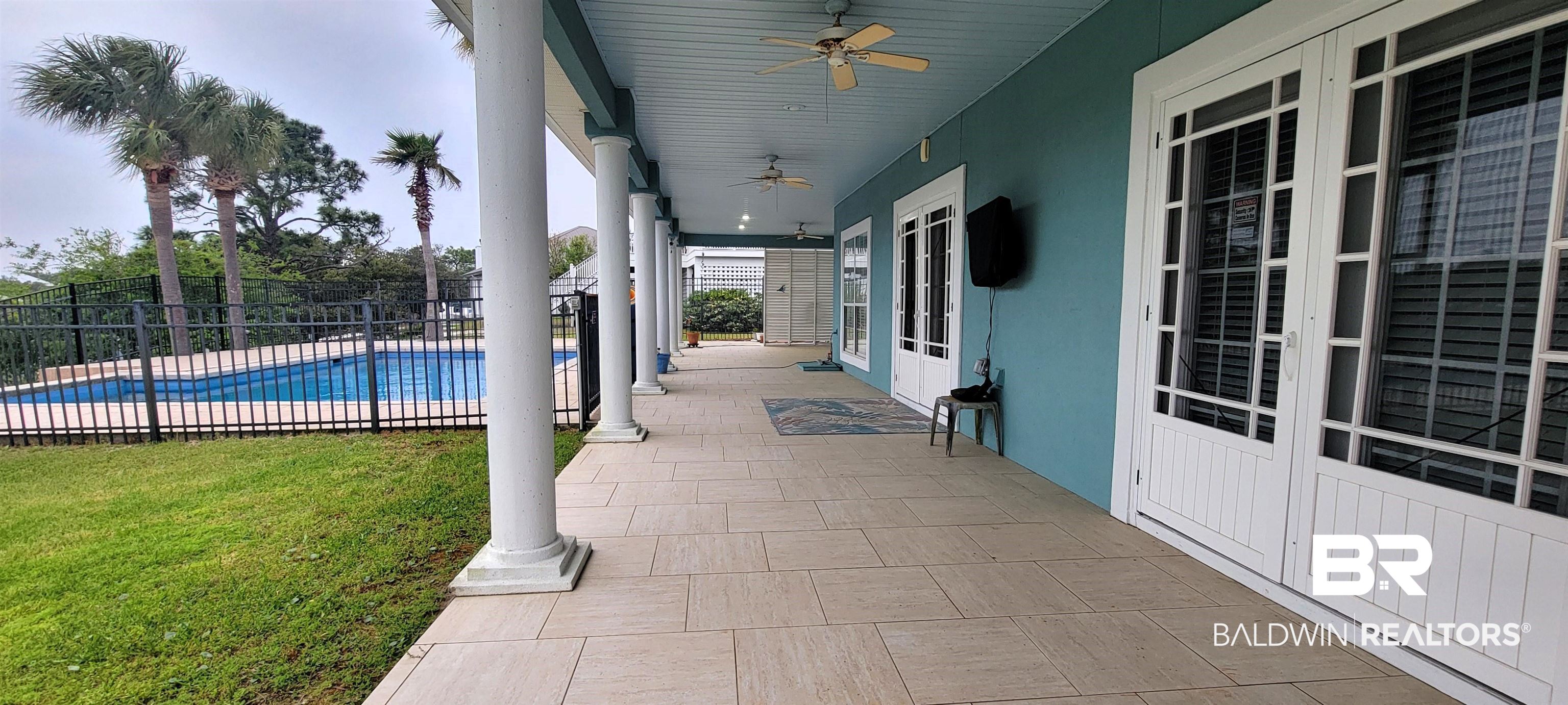 31821 River Road Orange Beach, AL 36561 - Photo 14 of 17 Covered patio back porch overlooking pool & canal.