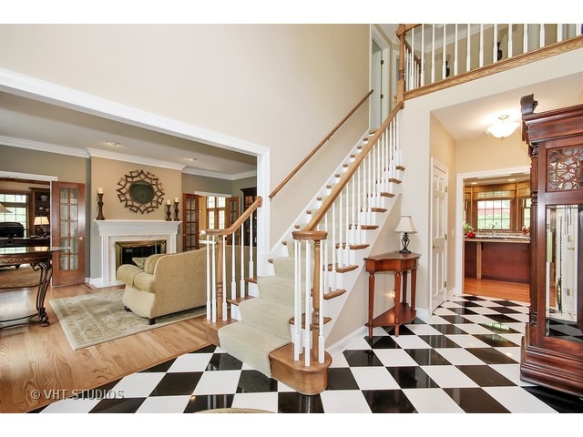 4N632 Hidden Oaks Road St. Charles, IL 60175 - Photo 2 of 25 a living room with furniture and a black white checkered floor with a black white checkered floor