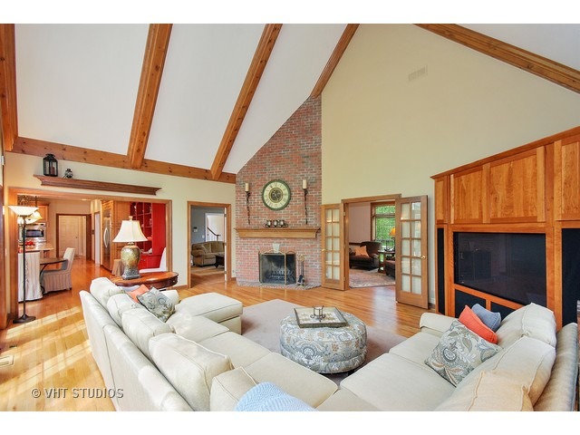 4N632 Hidden Oaks Road St. Charles, IL 60175 - Photo 13 of 25 a living room with furniture a fireplace and a flat screen tv