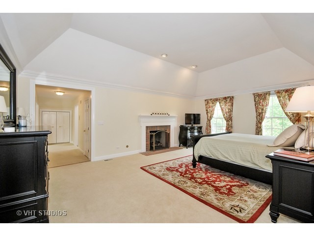 4N632 Hidden Oaks Road St. Charles, IL 60175 - Photo 16 of 25 a living room with furniture a fireplace and a flat screen tv