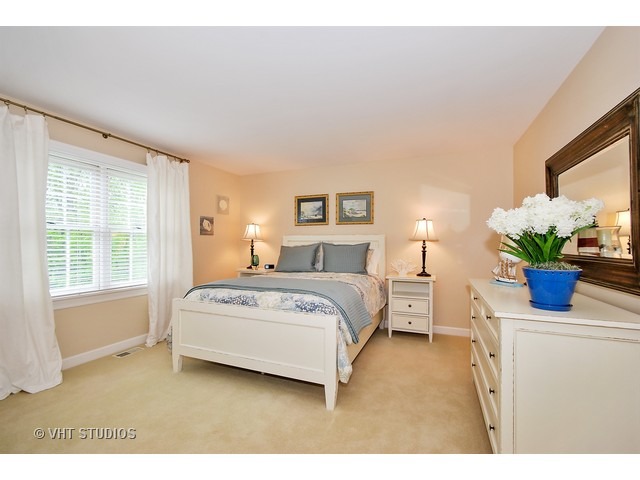 4N632 Hidden Oaks Road St. Charles, IL 60175 - Photo 19 of 25 a bedroom with a bed potted plant on the dresser and mirror