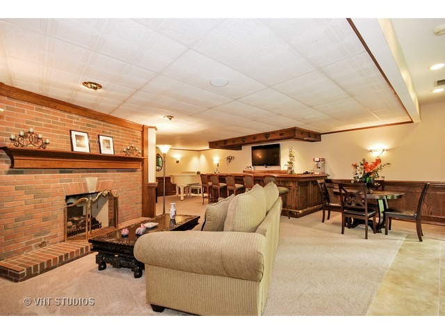 4N632 Hidden Oaks Road St. Charles, IL 60175 - Photo 24 of 25 a living room with furniture a fireplace and a kitchen view