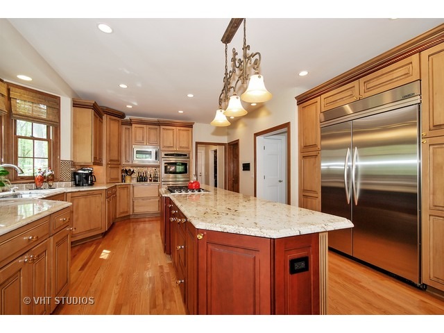 4N632 Hidden Oaks Road St. Charles, IL 60175 - Photo 8 of 25 a kitchen with stainless steel appliances kitchen island granite countertop a refrigerator and a sink