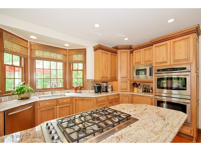 4N632 Hidden Oaks Road St. Charles, IL 60175 - Photo 9 of 25 a kitchen with stainless steel appliances kitchen island granite countertop a refrigerator stove top oven and sink