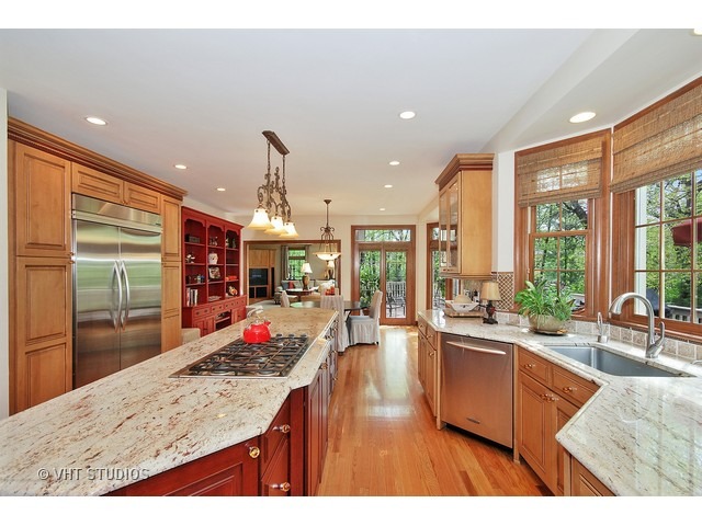 4N632 Hidden Oaks Road St. Charles, IL 60175 - Photo 10 of 25 a open kitchen with granite countertop a sink dishwasher stove and wooden cabinets