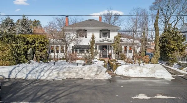 a front view of a house with yard and sitting area
