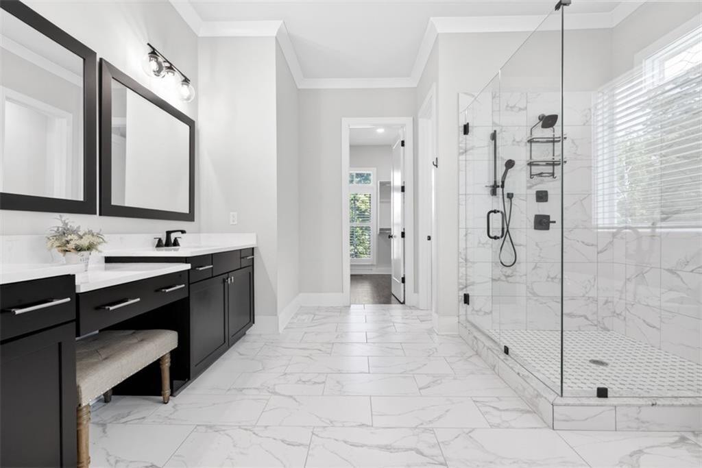 3528 North Bogan Road Buford, GA 30519 - Photo 30 of 79 a spacious bathroom with a shower sink and mirror