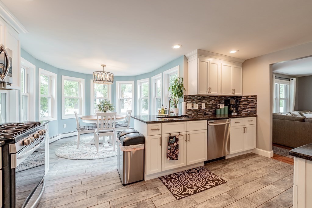 17 Andover Road Longmeadow, MA 01106 - Photo 11 of 40 a kitchen with stainless steel appliances kitchen island granite countertop a stove a sink and white cabinets