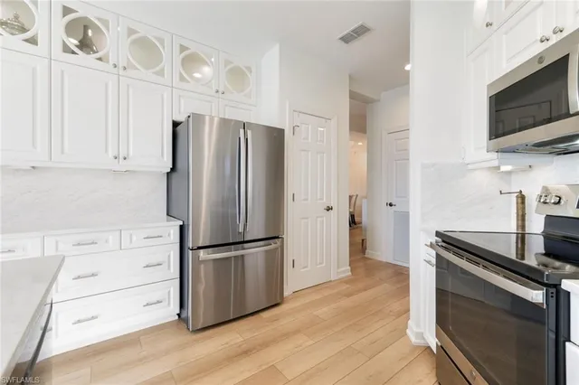 a kitchen with stainless steel appliances a refrigerator stove and microwave