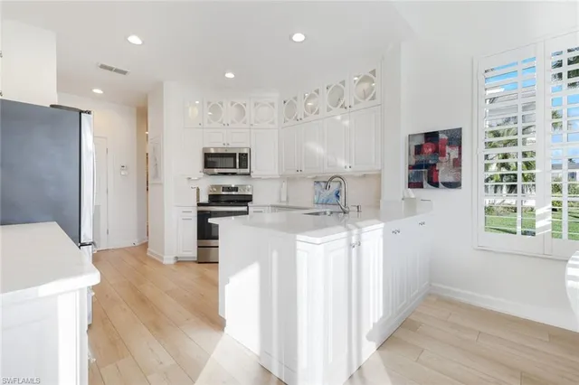 a kitchen with stainless steel appliances granite countertop a refrigerator and a stove