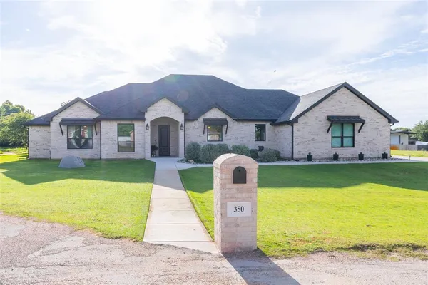 a front view of house with yard and swimming pool