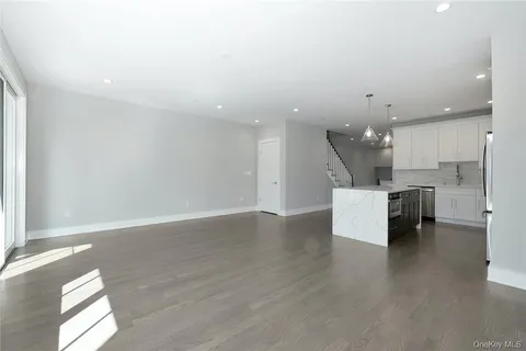 a view of kitchen with kitchen island microwave and cabinets