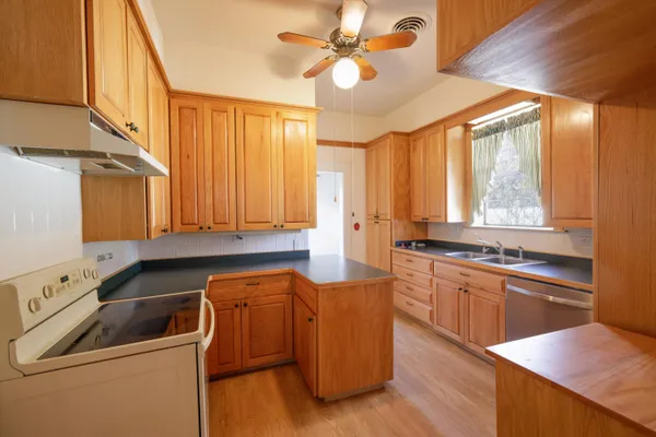 a kitchen with wooden cabinets and sink