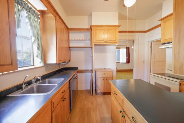 a kitchen with stainless steel appliances a sink and cabinets
