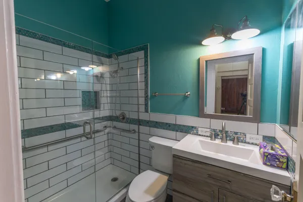 a bathroom with a sink toilet and shower