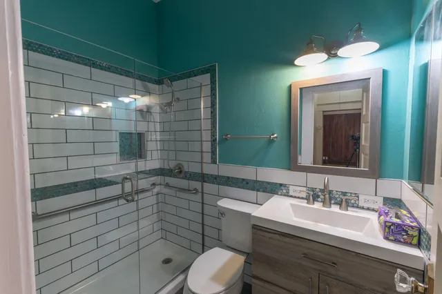 a bathroom with a sink toilet and shower