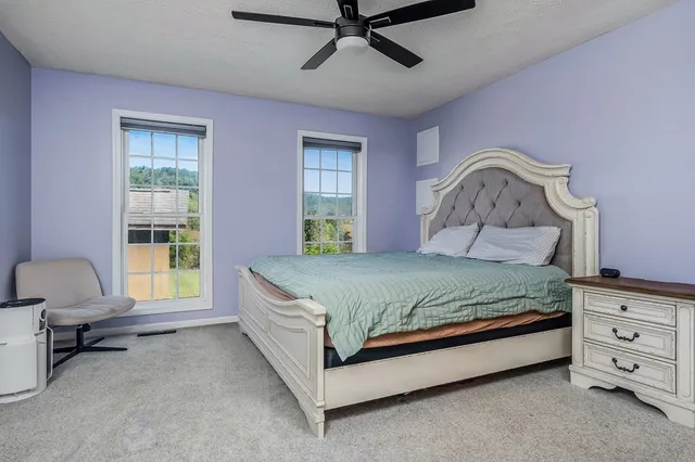 a bedroom with a bed dresser and a window