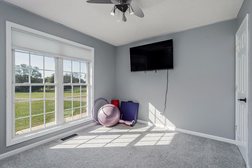 1945 Golden Mountain Road Sparta, TN 38583 - Photo 24 of 47 a living room with a flat screen tv and a floor to ceiling window