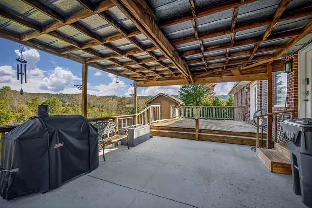 a view of a backyard with swimming pool and green space