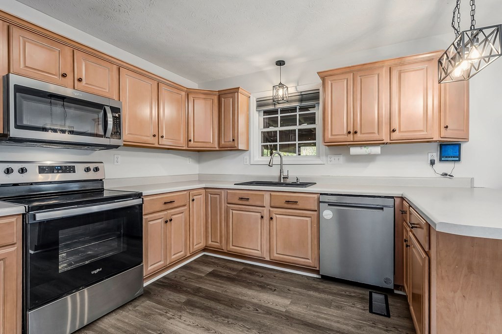 1945 Golden Mountain Road Sparta, TN 38583 - Photo 8 of 47 a kitchen with stainless steel appliances granite countertop a stove a sink dishwasher and a microwave oven with cabinets