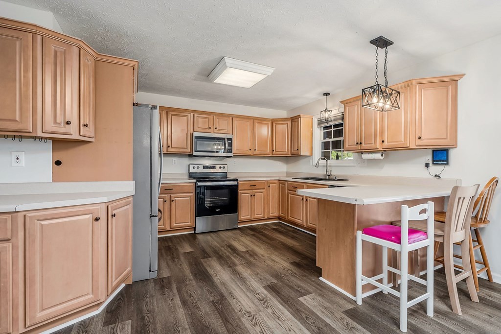 1945 Golden Mountain Road Sparta, TN 38583 - Photo 10 of 47 a kitchen with granite countertop wooden floors appliances and white cabinets