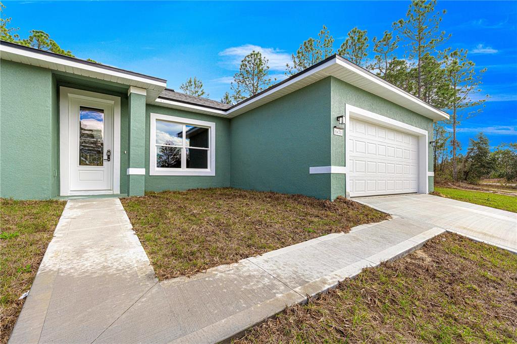 6430 Southwest 144th St Road Ocala, FL 34473 - Photo 1 of 1 a front view of a house with a yard