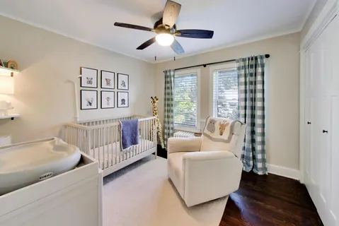 a bedroom with furniture and a large window