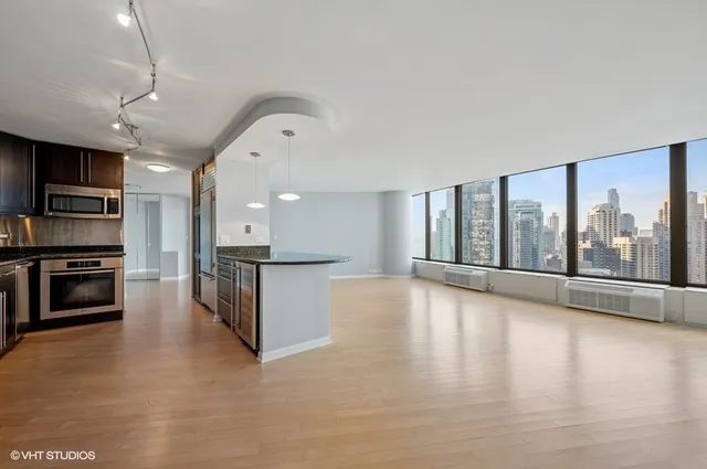 a view of kitchen with microwave and wooden floor
