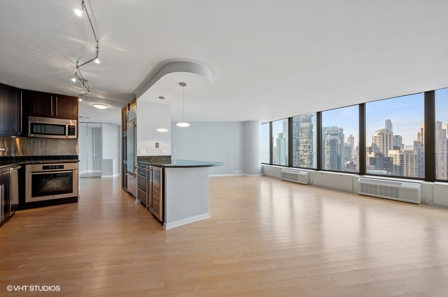 505 North Lake Shore Drive, Unit 4112 Chicago, IL 60611 - Photo 12 of 29 a view of kitchen with microwave and wooden floor